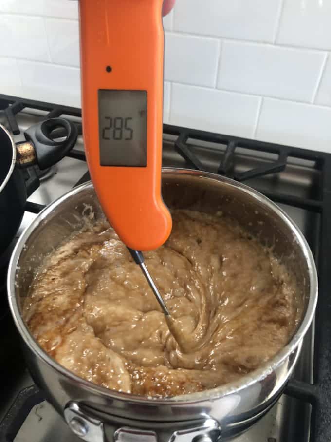 boiling toffee with a thermometer on the stove