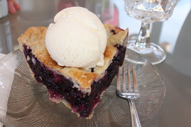 the best blueberry pie recipe with a scoop of vanilla ice cream on top 