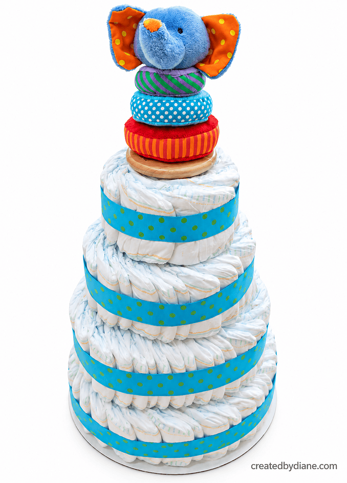 diy-diaper-cake-baby-shower with a toy on top, diapers placed in circles with ribbon for easy removal and use all instructions at createdbydiane