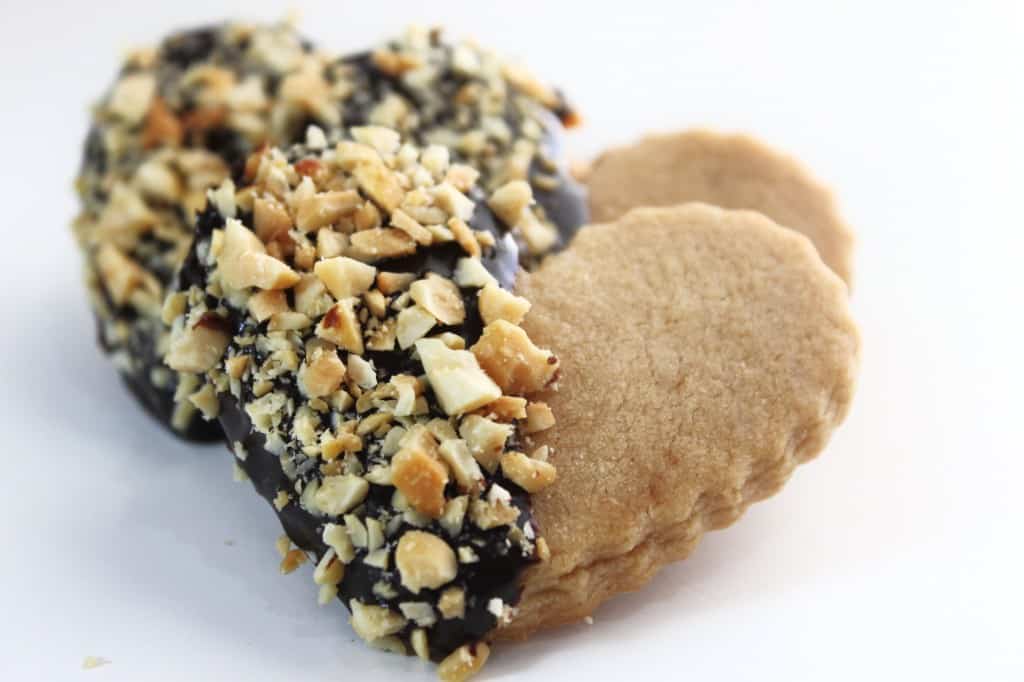 ganache on cookies topped with nuts