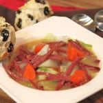 corned beef soup in a bowl with irish soda bread muffins