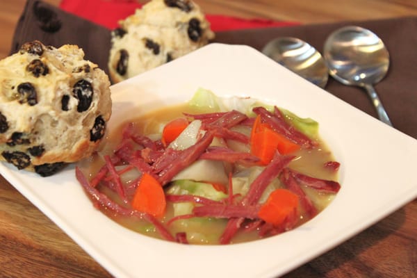 corned beef soup in a bowl with irish soda bread muffins