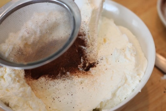 Instant coffee mixing into Italian Buttercream Frosting