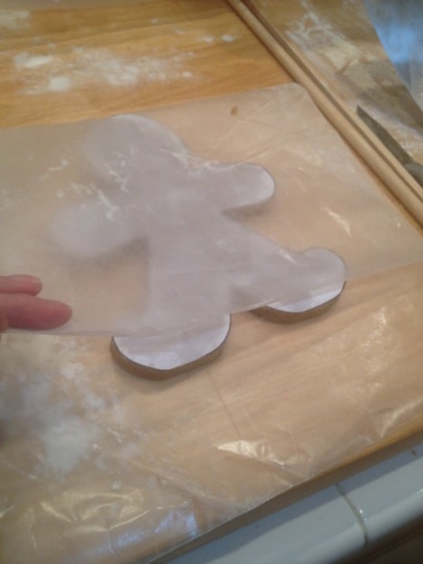 moving giant gingerbread cookie to baking sheet.jpg