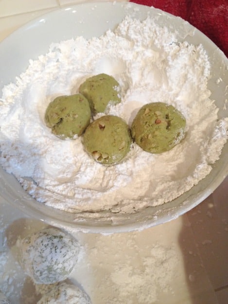 rolling cookies in powdered sugar