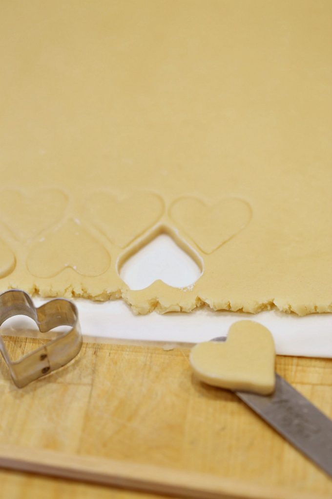 cutting-cookies-with-cookie-cutters-and-moving-them-to-a-baking-sheet-for-perfect-cookies-createdbydiane