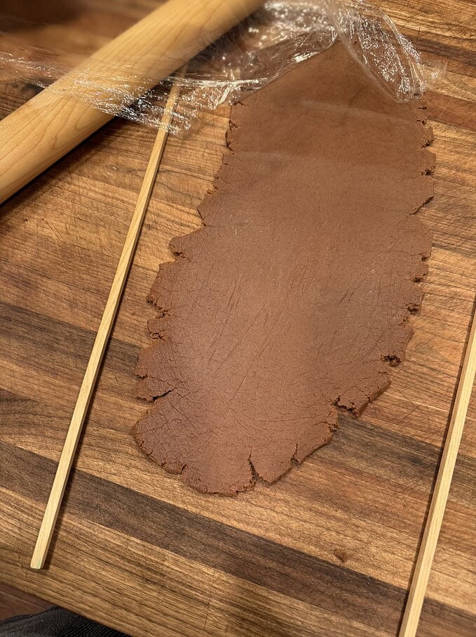 use plastic wrap instead of extra flour when rolling out cookies