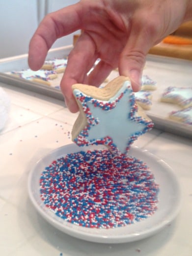 decorating cookies with icing and sprinkles