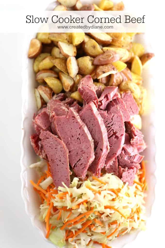 sliced slow cooked corned beef with roasted potatoes and sautéed cabbage