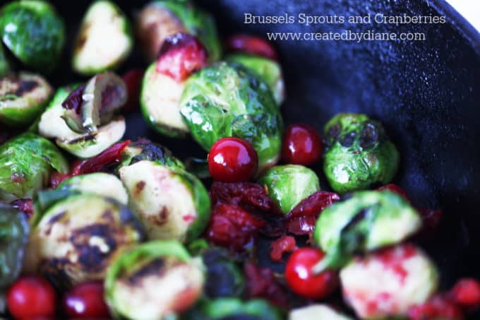 cast iron skillet cooking vegetables brussels sprouts with cranberries and jalapeno