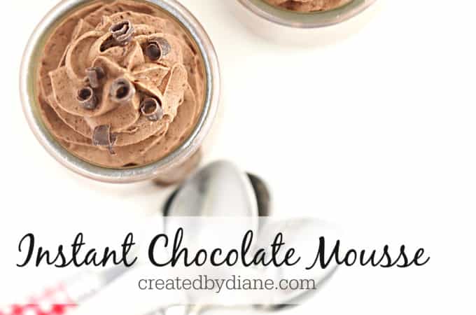 glass jars with chocolate mousse with chocolate curls on top