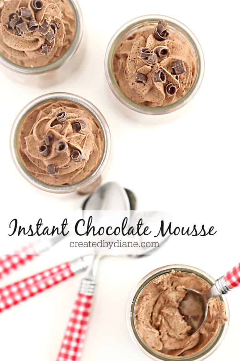 glass jars with chocolate mousse with chocolate curls on top