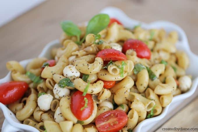 caprese pasta salad with large elbow noodles grape tomatoes, pearl mozzarella, fresh basil and a homemade balsamic dressing createdbydiane.com