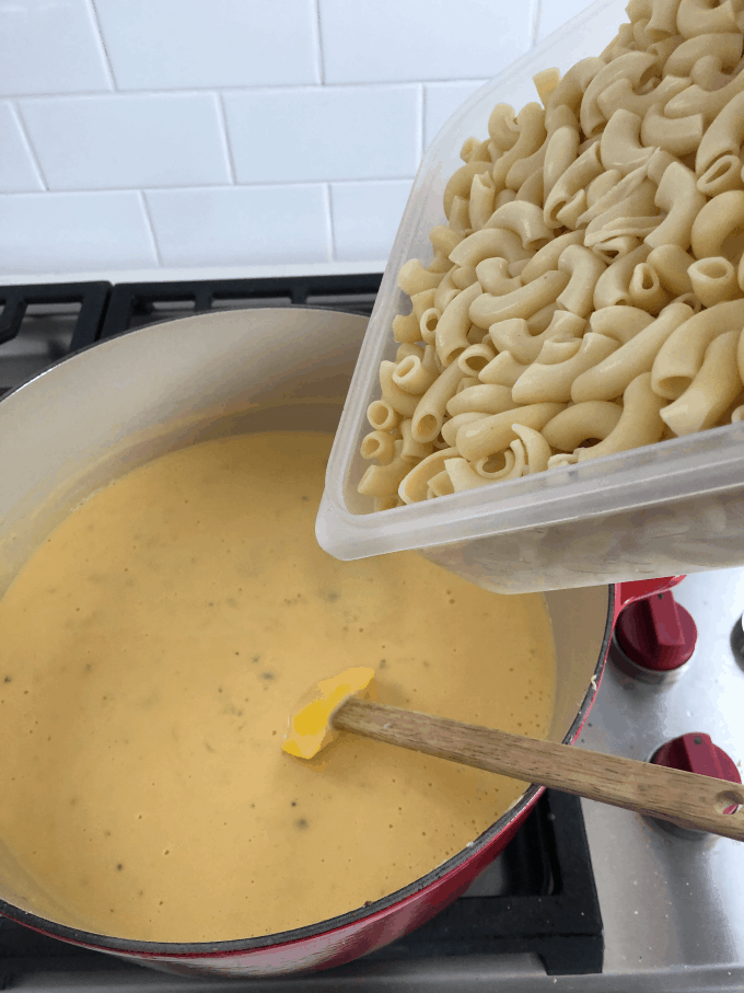 adding pasta to cheese sauce createdbydiane.com
