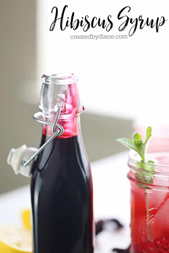 glass bottle with hinge lid full of bright pink hibiscus syrup