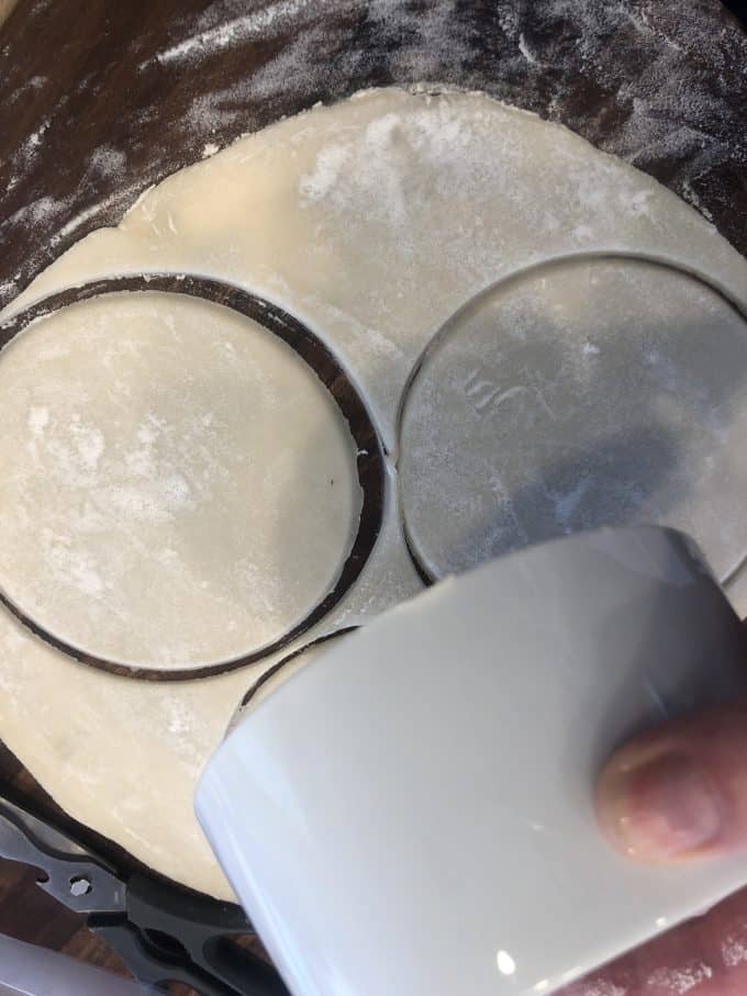 cutting pie crust with the rim of a bowl for pot pies