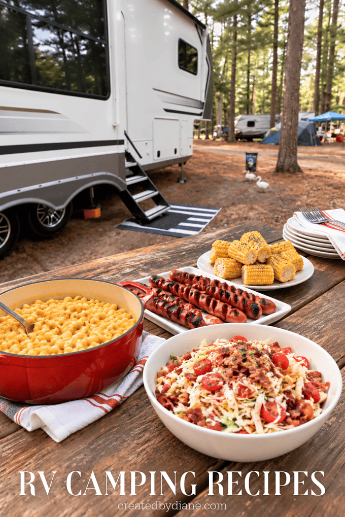 rv glamping recipes, camping recipes rv with picnic talbe and mac and cheese, spiral hot dogs and corn on the cob, blt cole slaw, a feast all camping would love