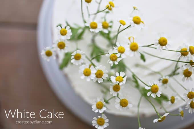 white cake 2 layer white almond sour cream cake with camomile flowers createdbydiane.com