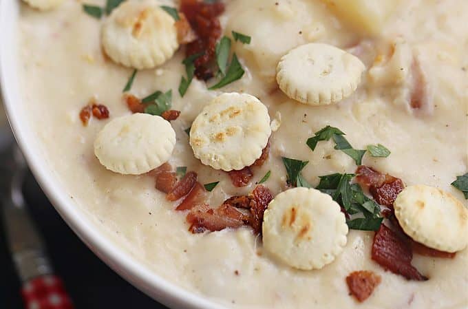 large white bowl of thick and creamy clam chowder, bacon, potato, clams createdbydiane.com