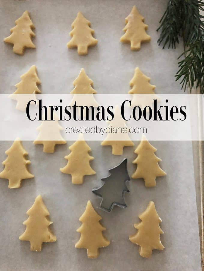 christmas tree cookie dough on baking sheet, cookie cutter