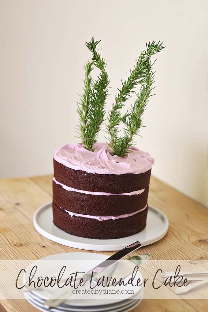 chocolate layer cake with lavender color and flavored frosting with rosemary tied to look like bunny ears on top of the cake