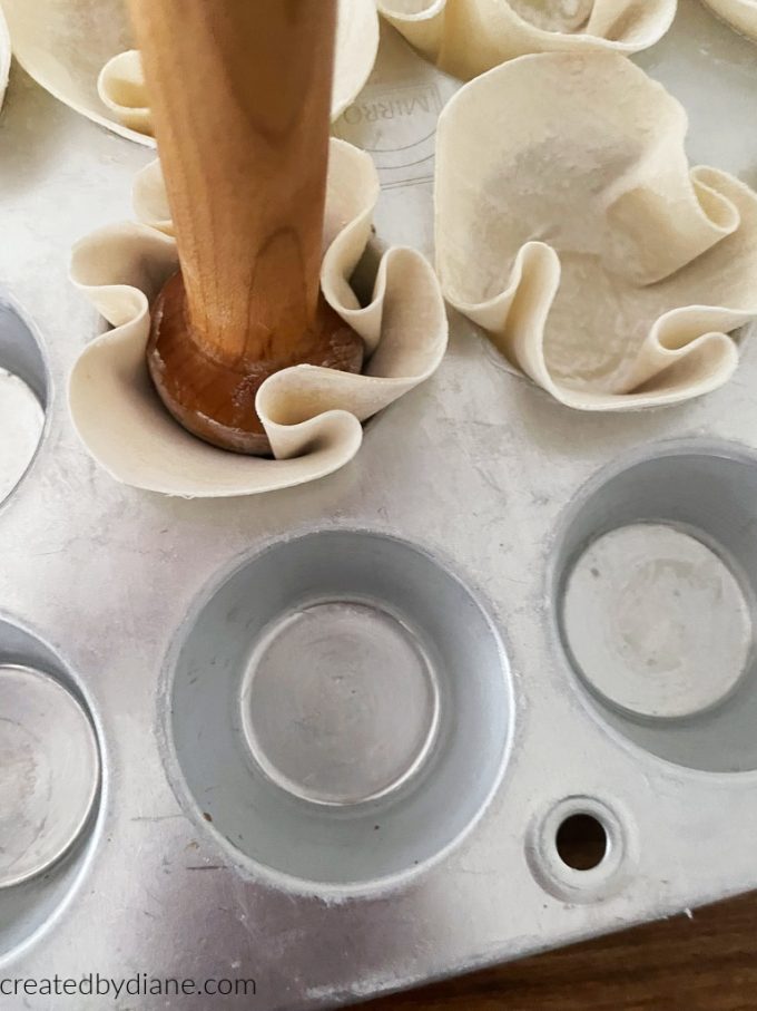 pressing wonton wrappers into mini muffin tin for individual appetizers createdbydiane.com