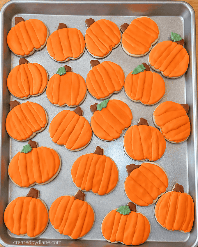 pumpkin shaped sugar cookies with orange royal icing
