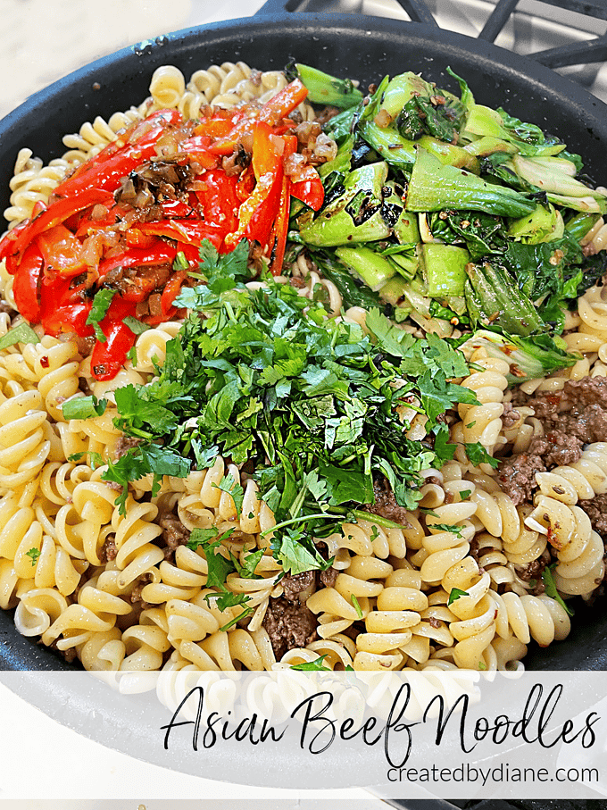 skillet with rotini pasta, ground beef, peppers, bok choy, cilantro